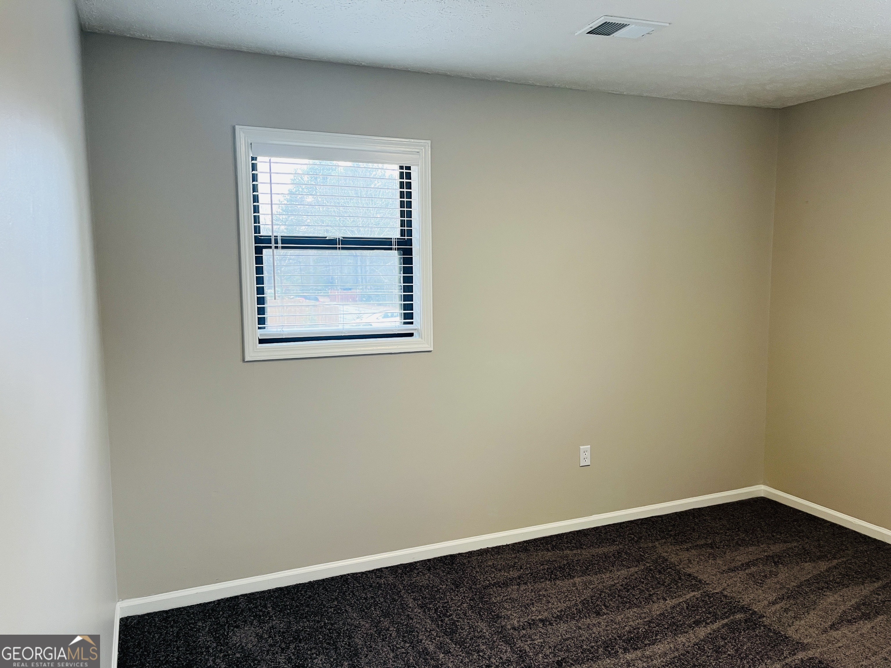 1075 Eastview Road Northeast, Unit A Conyers, GA 30012 - Photo 17 of 21 an empty room with a window