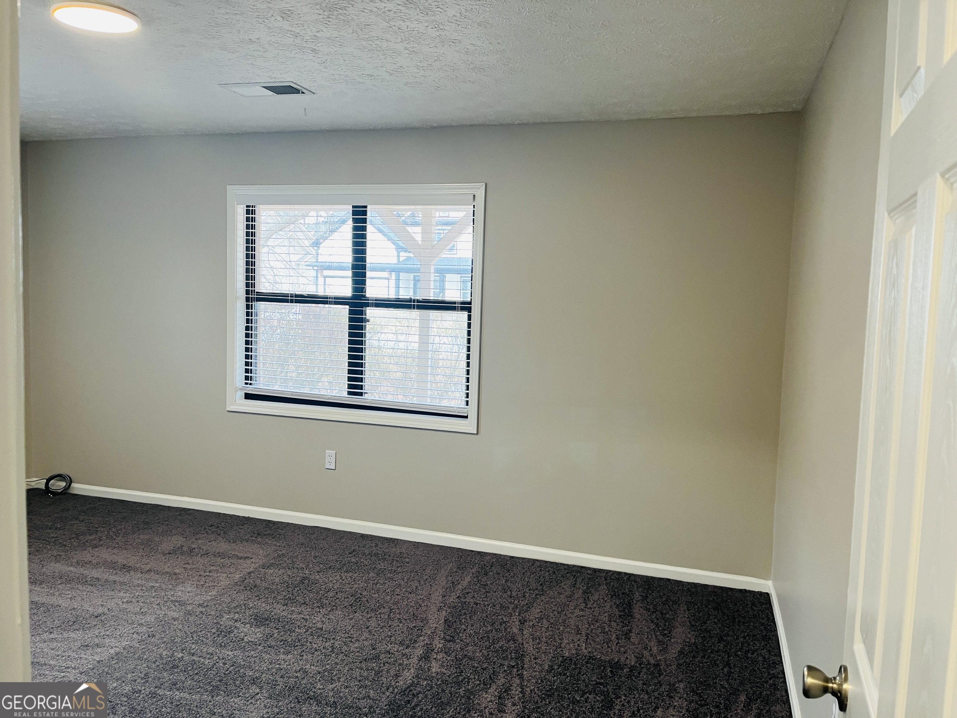 1075 Eastview Road Northeast, Unit A Conyers, GA 30012 - Photo 10 of 21 an empty room with a window