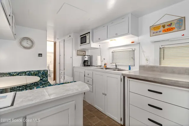a open kitchen with stainless steel appliances granite countertop a sink and a refrigerator