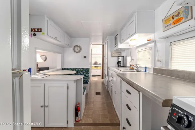 a spacious bedroom with a bed and a chandelier
