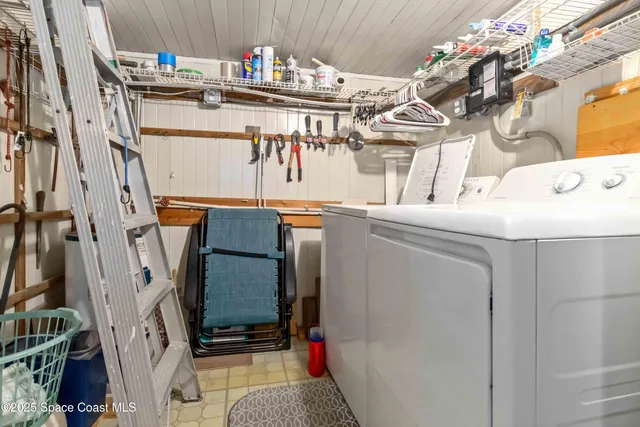 a view of a swimming pool with a lawn chairs and a big yard