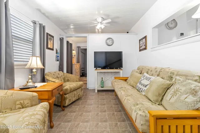 a living room with furniture and a lamp