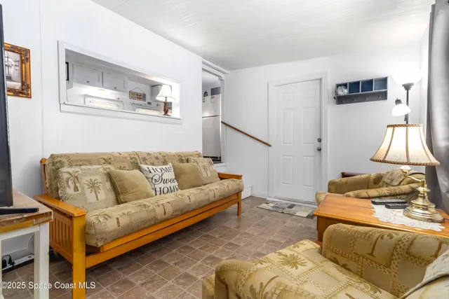 a kitchen with white cabinets and sink