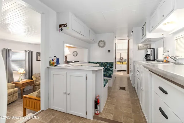 a kitchen with cabinets and window