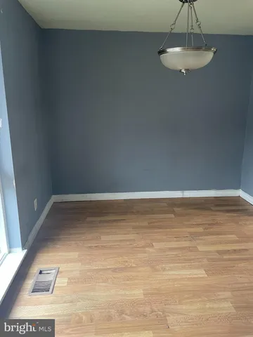 a view of a room with an empty space and a window