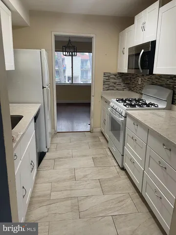 a kitchen with a stove a sink and a refrigerator