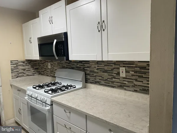 a kitchen with a stove and a microwave
