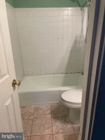 a bathroom with a toilet and a bathtub
