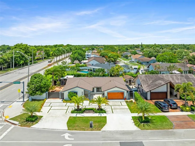 an aerial view of multiple house with yard