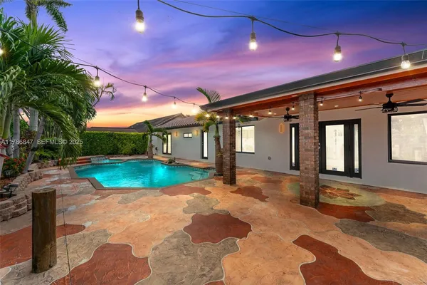 a view of a porch with a table and chairs and potted plants