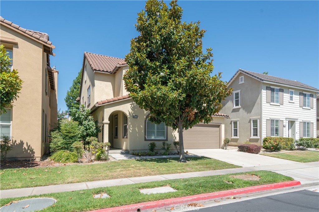 8656 Harvest Place Rancho Cucamonga, CA 91730 - Photo 2 of 39 a front view of a house with a yard