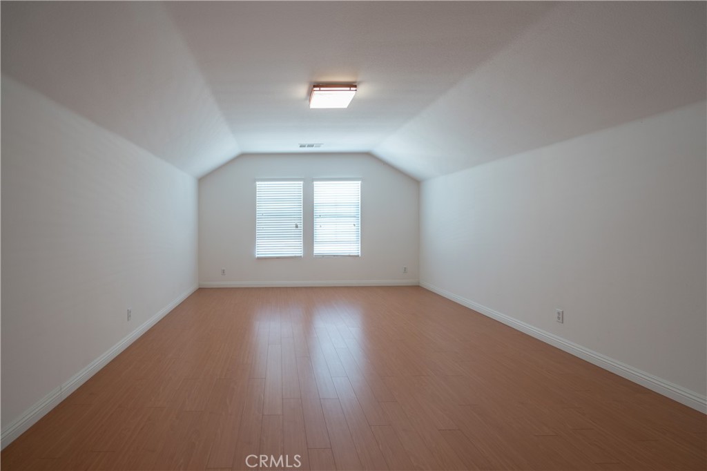 8656 Harvest Place Rancho Cucamonga, CA 91730 - Photo 26 of 39 an empty room with wooden floor and windows