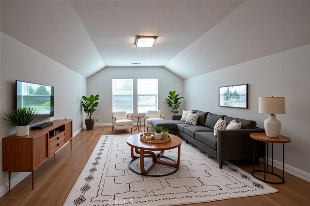 8656 Harvest Place Rancho Cucamonga, CA 91730 - Photo 27 of 39 a living room with furniture a window and a flat screen tv