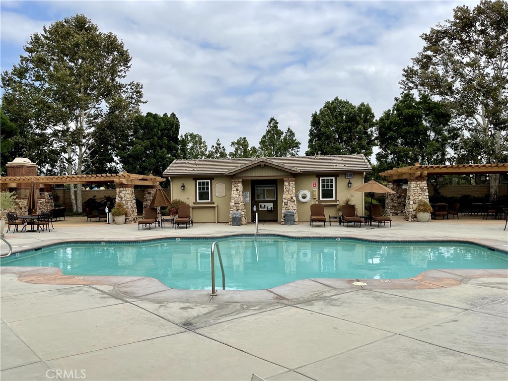 8656 Harvest Place Rancho Cucamonga, CA 91730 - Photo 33 of 39 a front view of a house with swimming pool having outdoor seating