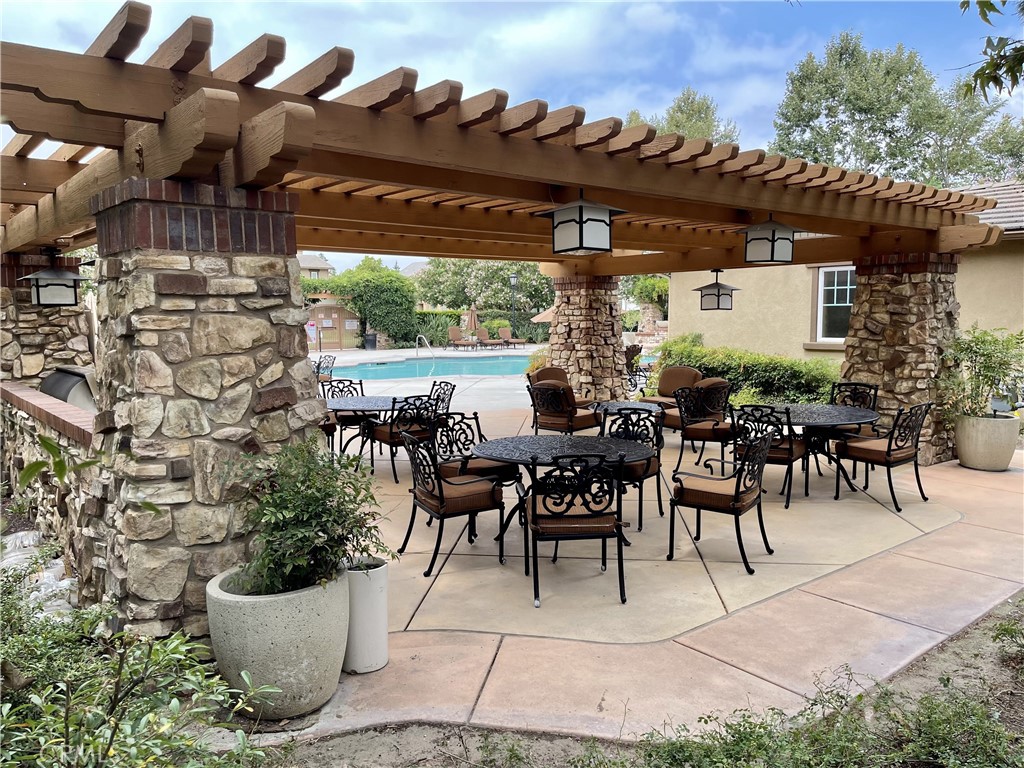 8656 Harvest Place Rancho Cucamonga, CA 91730 - Photo 35 of 39 a view of a patio with table and chairs potted plants