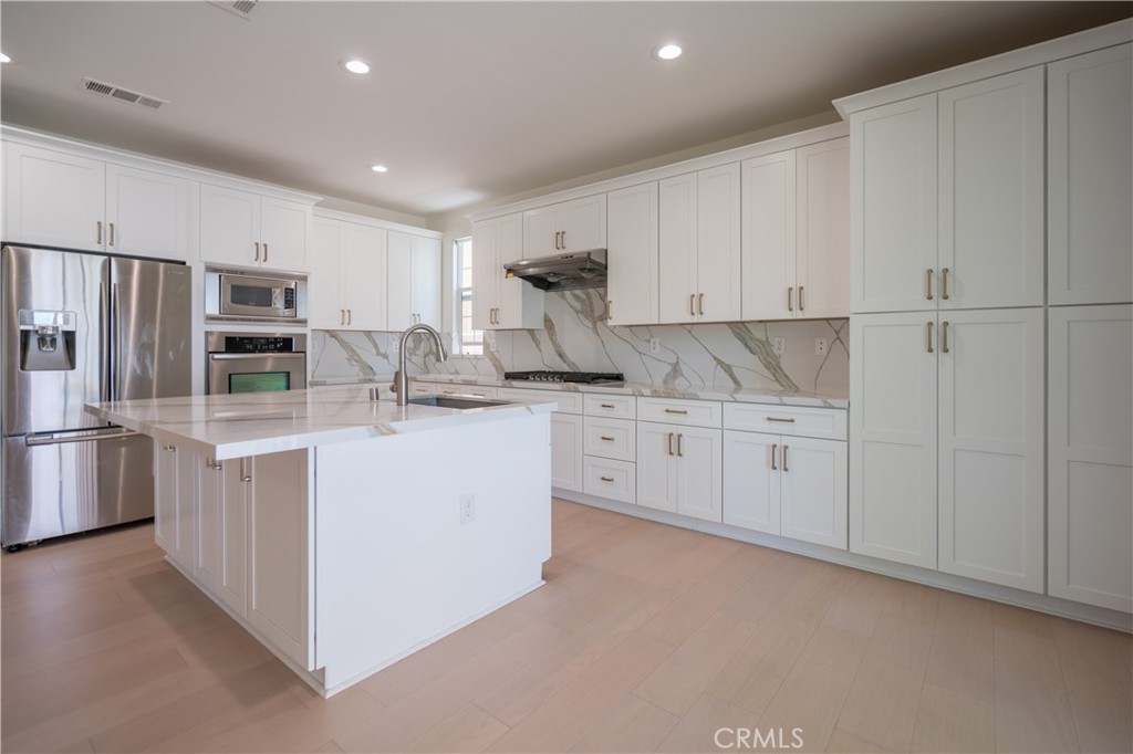 8656 Harvest Place Rancho Cucamonga, CA 91730 - Photo 9 of 39 a kitchen with white cabinets