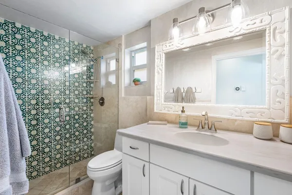 a bathroom with a sink toilet and shower