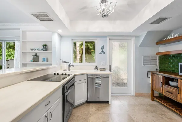 a kitchen with a sink stove and microwave
