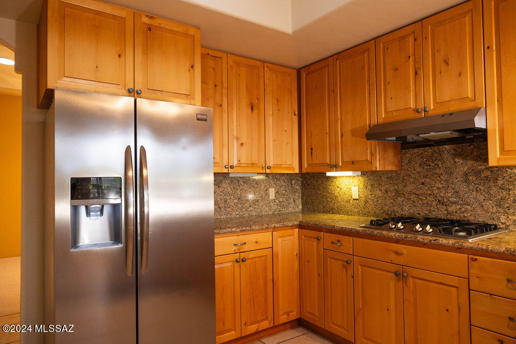 771 West Sedona Ridge Place Oro Valley, AZ 85755 - Photo 10 of 22 a kitchen with stainless steel appliances granite countertop a refrigerator a stove and a sink