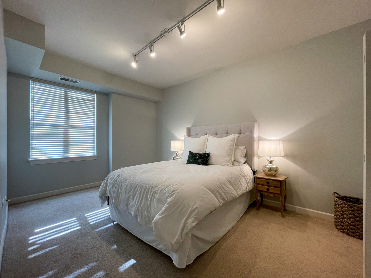 451 West Huron Street, Unit 709 Chicago, IL 60654 - Photo 7 of 19 a bedroom with a bed and a night stand