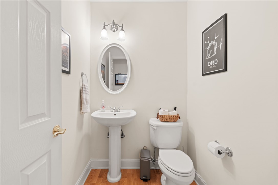 108 Winterbrook Circle Seneca, SC 29678 - Photo 25 of 40 A well-appointed half bath features a pedestal sink and warm wood flooring.