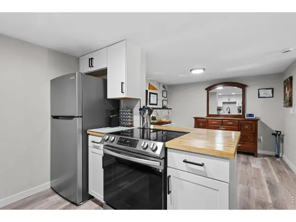 a kitchen with kitchen island a stove microwave and refrigerator