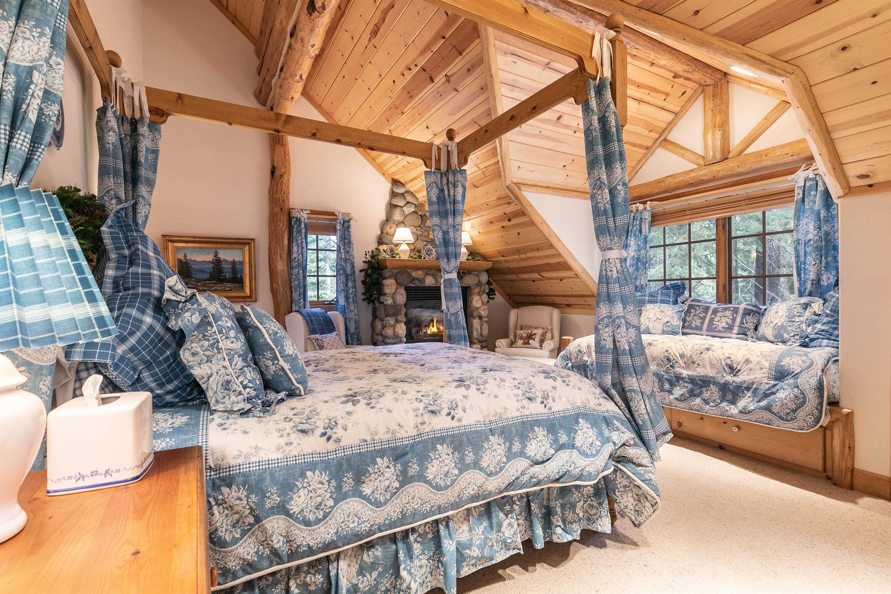 850 Beaver Pond Truckee, CA 96161 - Photo 12 of 21 a bedroom with a bed a large window and potted plants