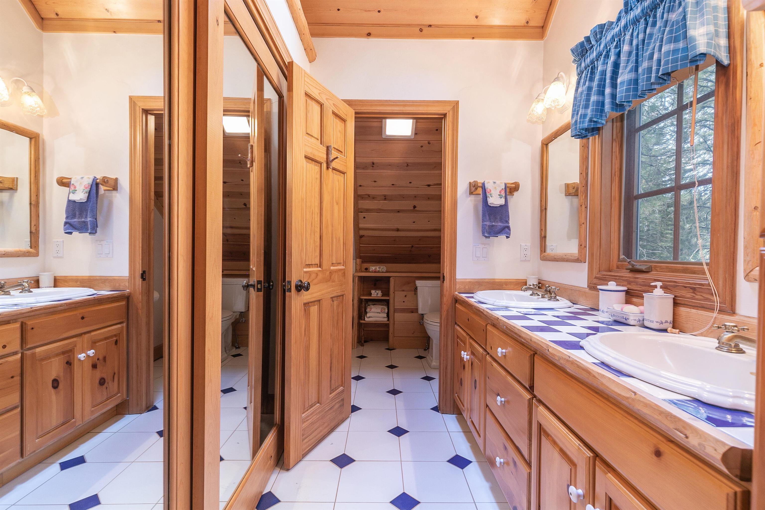 850 Beaver Pond Truckee, CA 96161 - Photo 13 of 21 a spacious bathroom with a double vanity sink a mirror and a shower