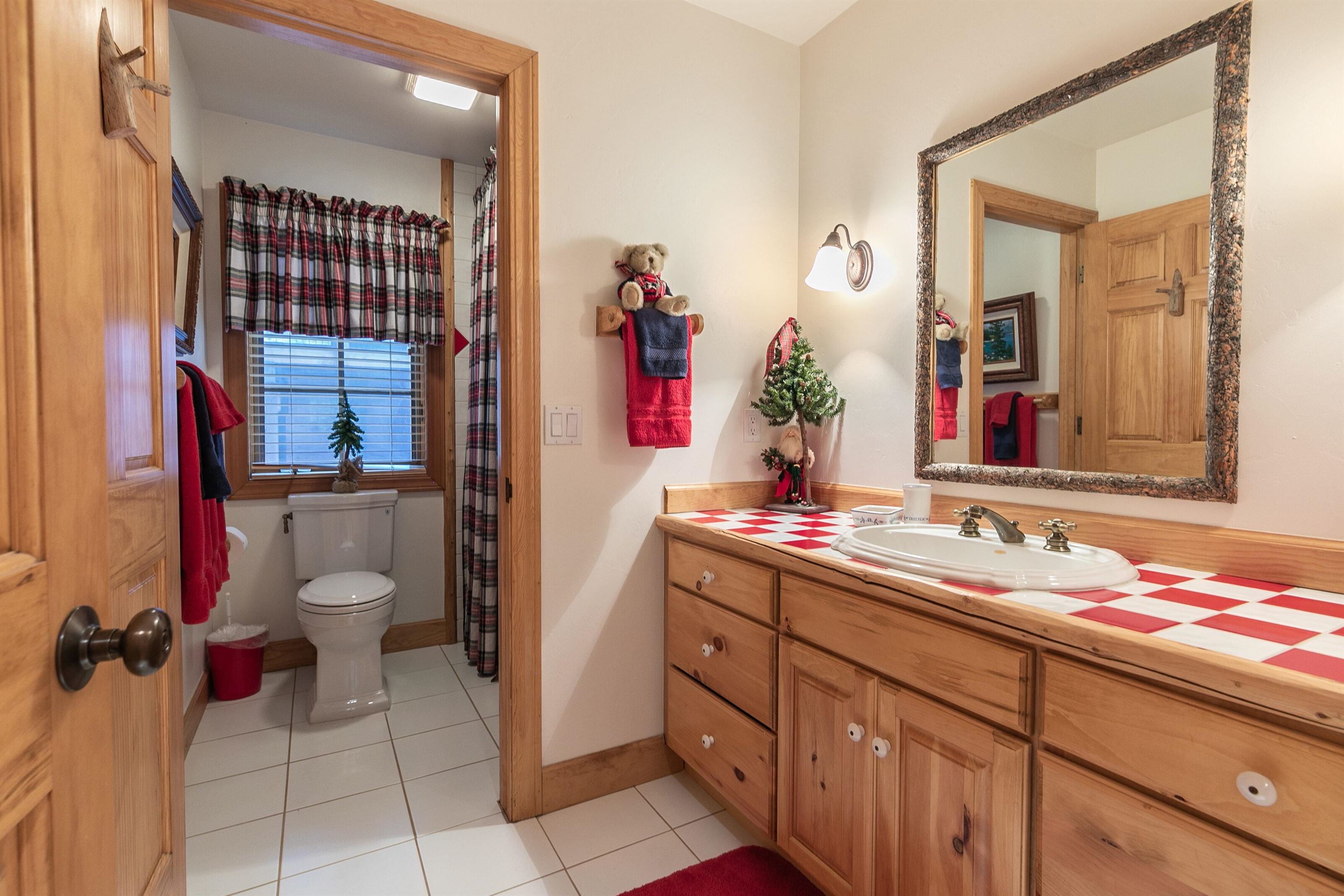 850 Beaver Pond Truckee, CA 96161 - Photo 18 of 21 a bathroom with a toilet sink and mirror