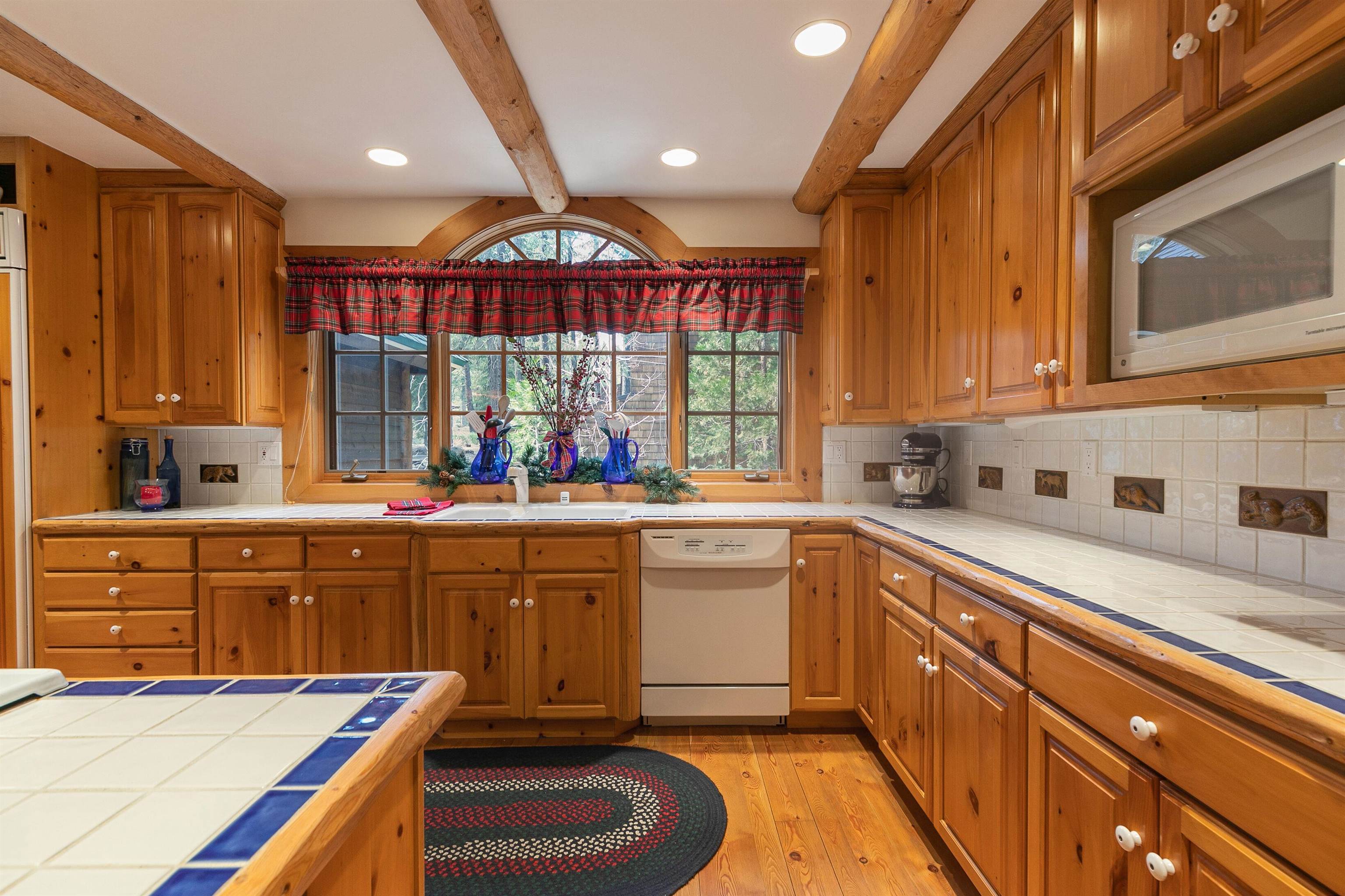 850 Beaver Pond Truckee, CA 96161 - Photo 9 of 21 a kitchen with a sink stove and cabinets