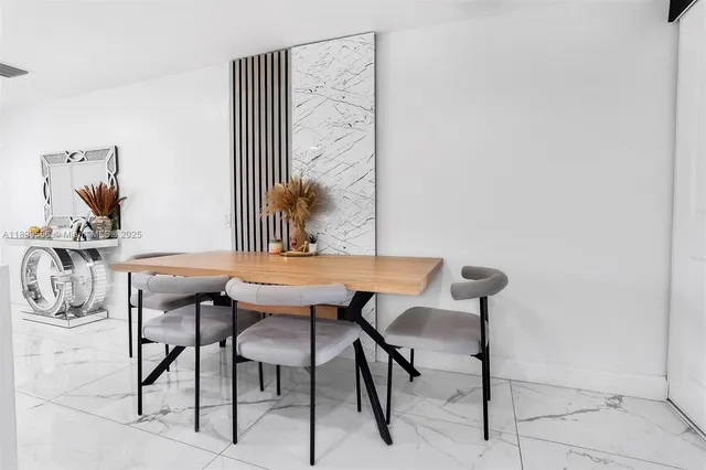 a view of a room with a table and chairs