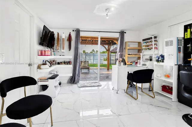 a living room with a bed furniture and a large window