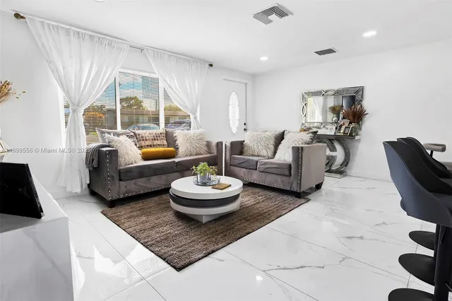 a living room with furniture and a large window