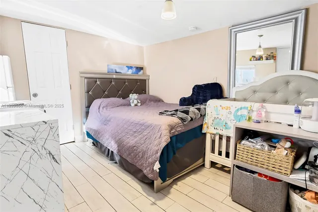 a bedroom with a large bed and a flat tv screen