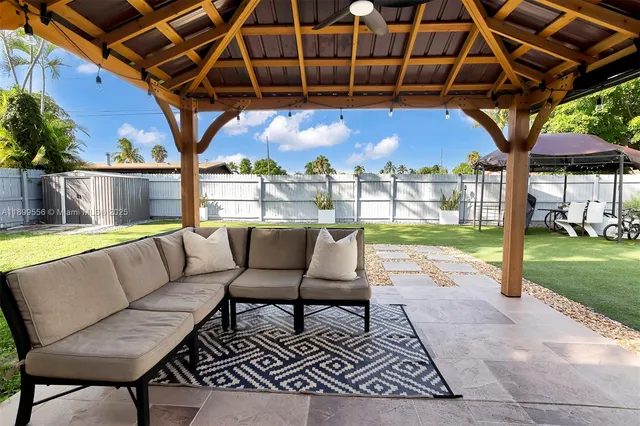 a view of a backyard with sitting area