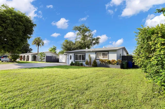 a front view of house with yard and outdoor seating