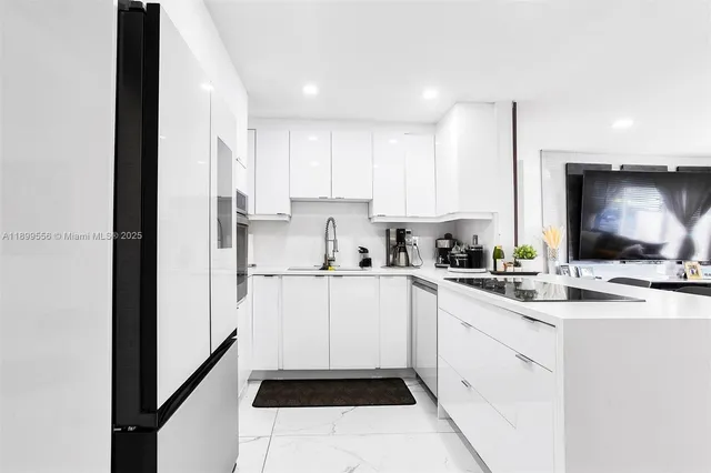 a kitchen with kitchen island white cabinets and white appliances