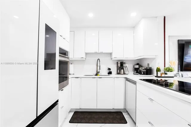 a kitchen with a sink a refrigerator and cabinets