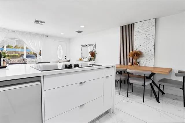 a kitchen with a sink cabinets and wooden floor
