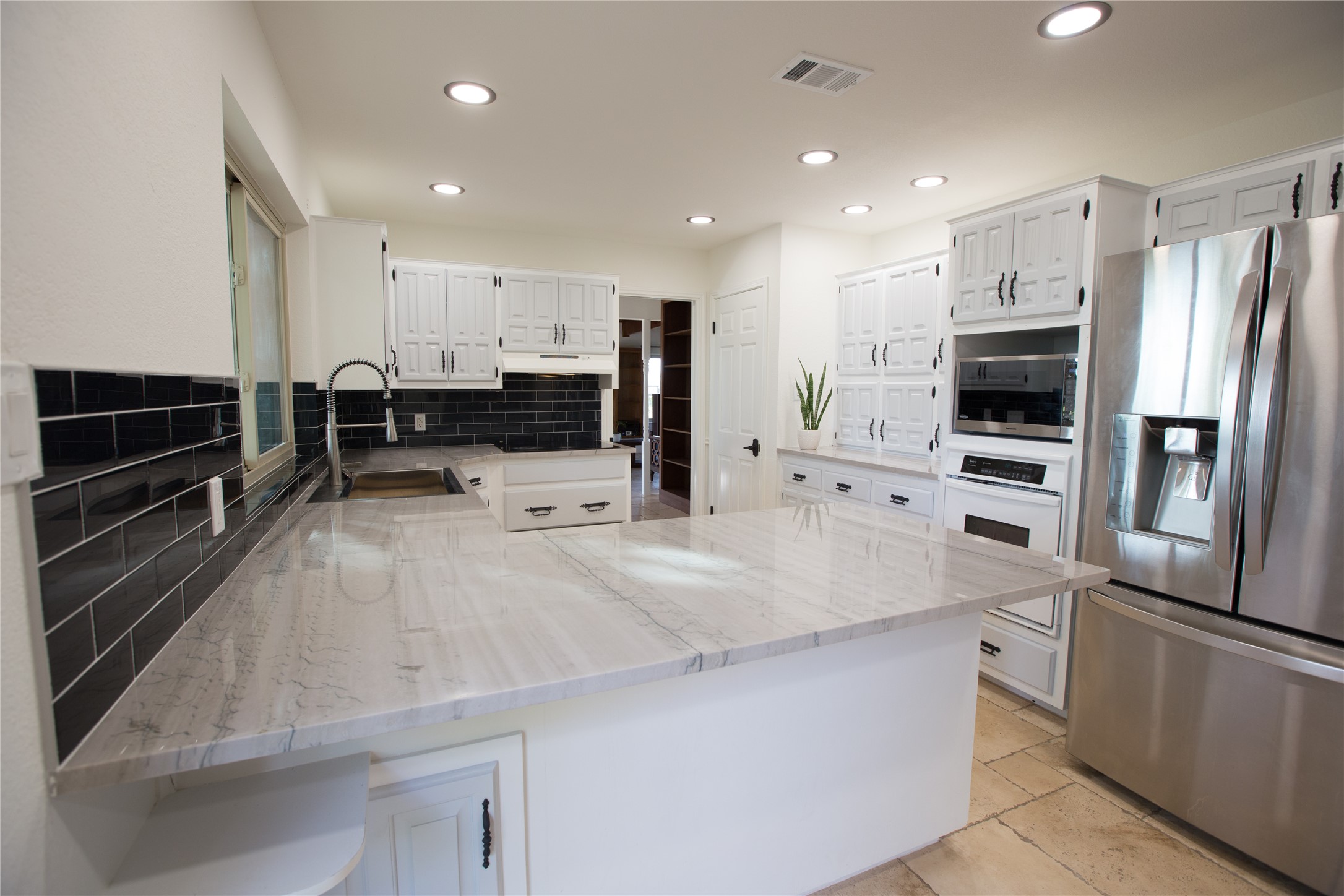 3517 Gattis School Road Round Rock, TX 78664 - Photo 2 of 16 Gleaming stone countertops and modern stainless steel appliances define this inviting culinary space.