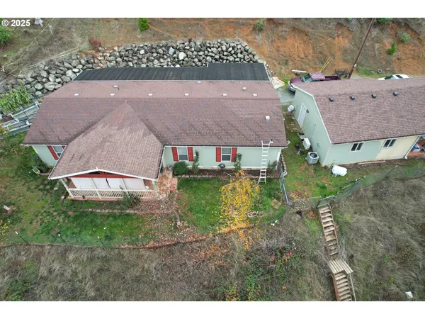 a aerial view of a house with a yard and lake view
