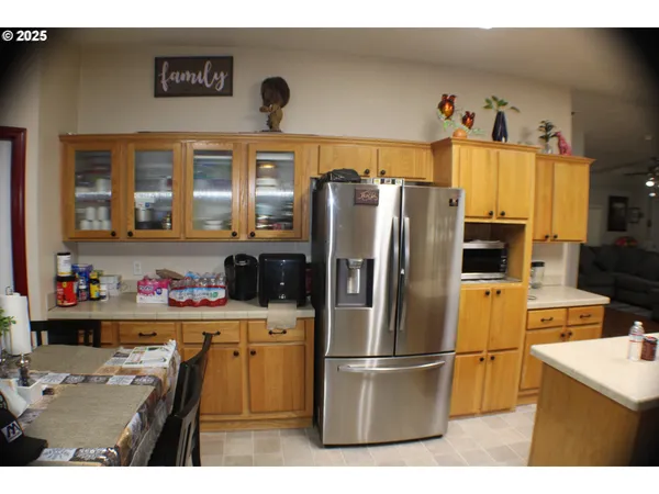 a kitchen with a refrigerator a stove top oven a sink and cabinets