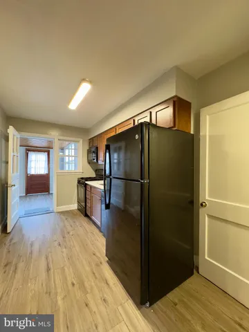 a kitchen with a sink and steel appliances