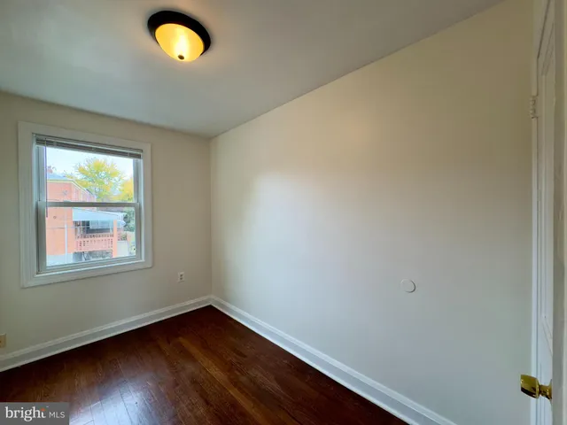 a view of walk in closet with wooden floor