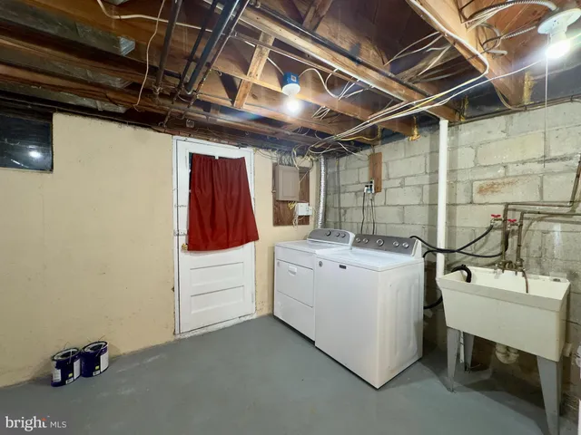 a view of storage and utility room with a hallway