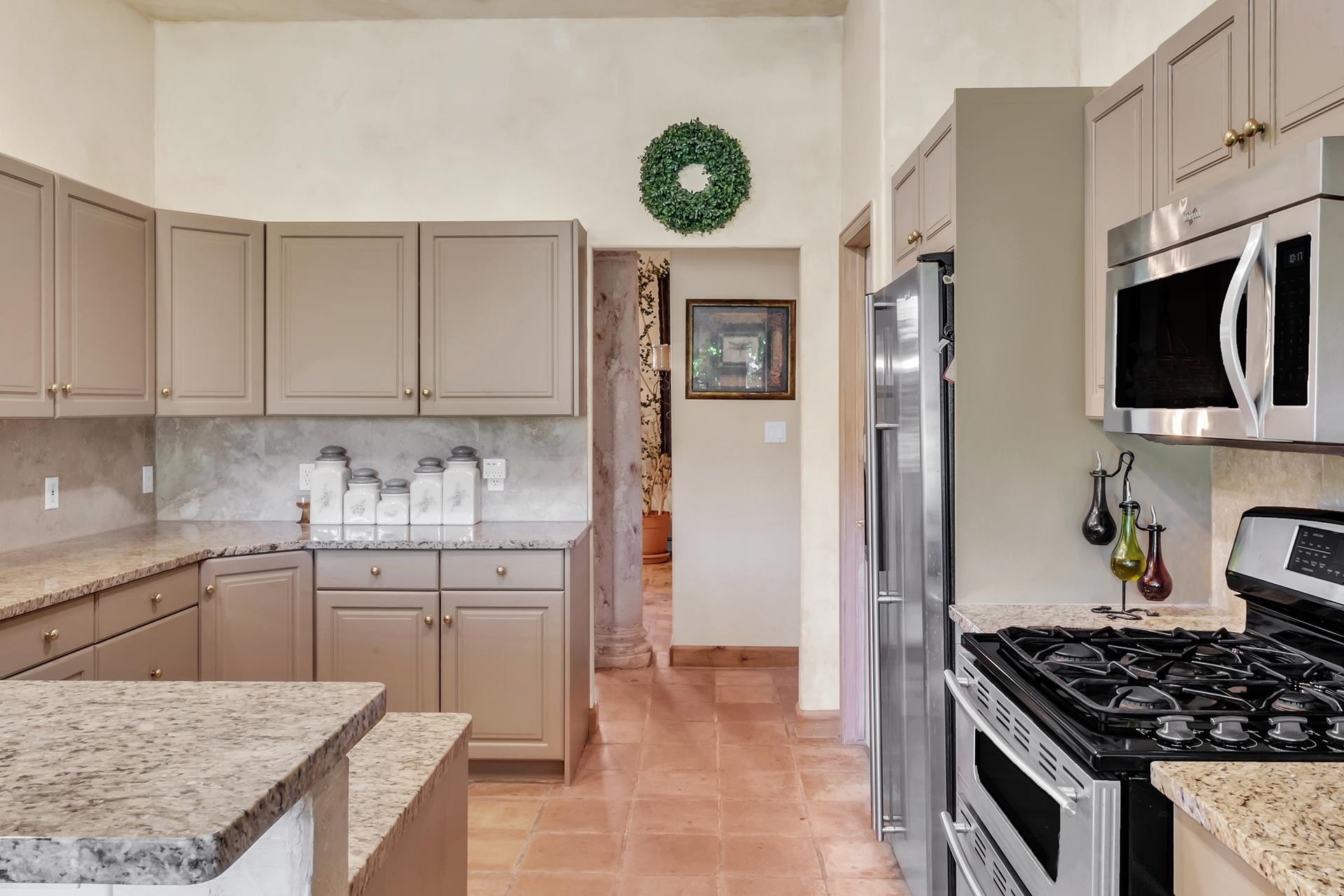 3310 C Road Palisade, CO 81526 - Photo 21 of 41 a kitchen with stainless steel appliances granite countertop a stove top oven a sink a refrigerator and white cabinets