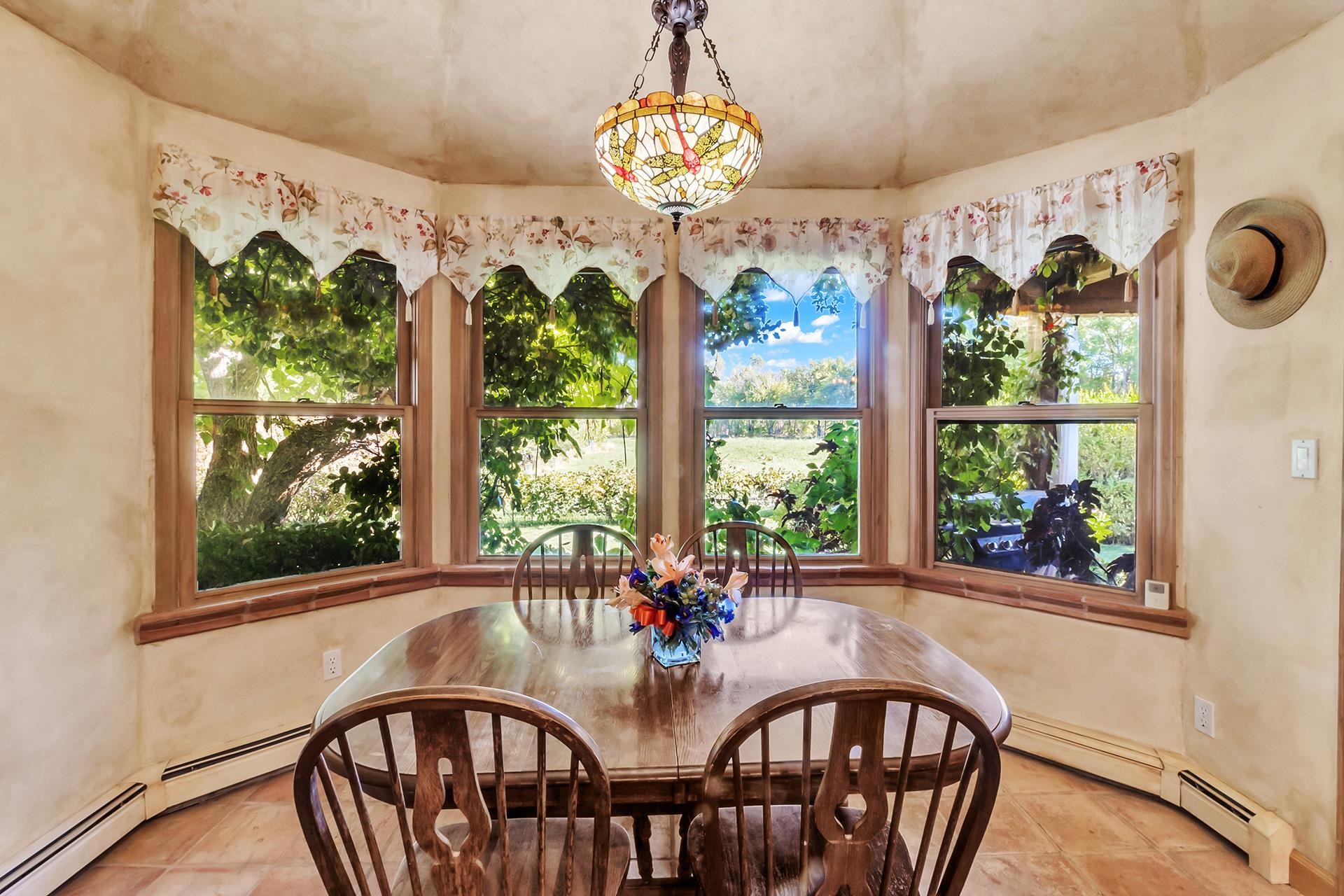 3310 C Road Palisade, CO 81526 - Photo 23 of 41 a view of a dining room with furniture a chandelier and a window