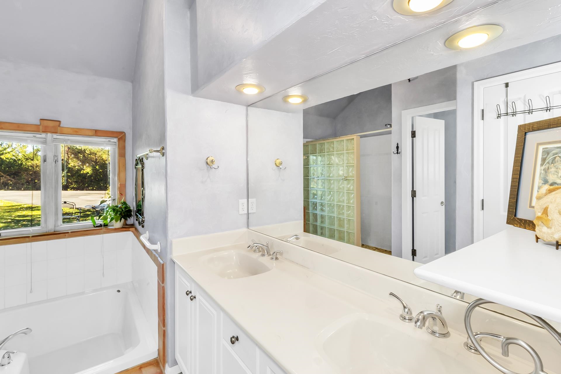 3310 C Road Palisade, CO 81526 - Photo 29 of 41 a spacious bathroom with a granite countertop sink and a large mirror