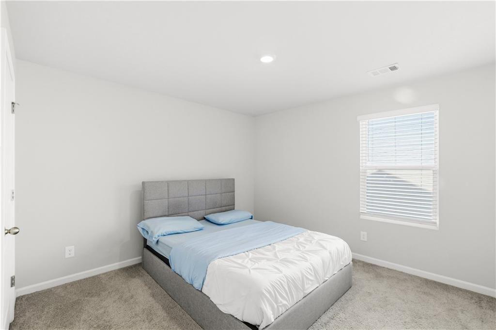 7626 Jennadee Drive Fairburn, GA 30213 - Photo 17 of 27 a bedroom with a bed and a window