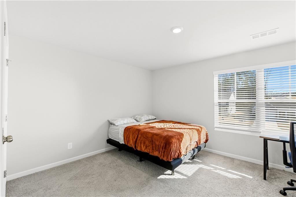 7626 Jennadee Drive Fairburn, GA 30213 - Photo 18 of 27 a room with a bed and a window